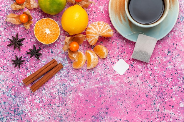 Foto grátis vista superior tangerinas azedas frescas com limões e xícara de chá no fundo rosa.