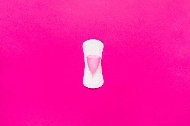 Vista superior toalha sanitária com copo menstrual