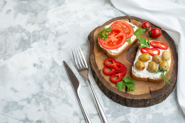Vista superior torradas saborosas com tomates e azeitonas na placa de madeira fundo branco pão hambúrguer lanche jantar sanduíche horizontal comida almoço