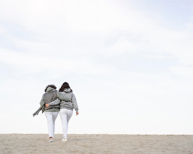 Foto grátis vista traseira de mãe e filha na praia