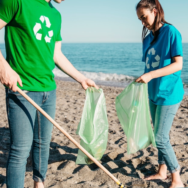 Foto grátis voluntários coletando lixo na praia