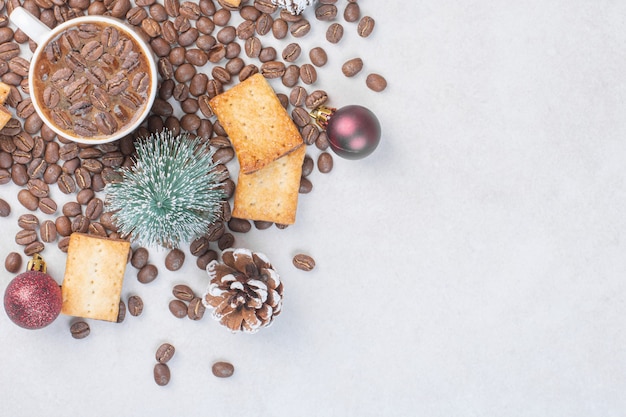 Xícara de café, biscoitos e enfeites de Natal na superfície da pedra.