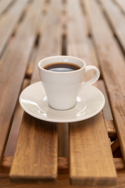 Xícara de café minimalista na mesa de madeira