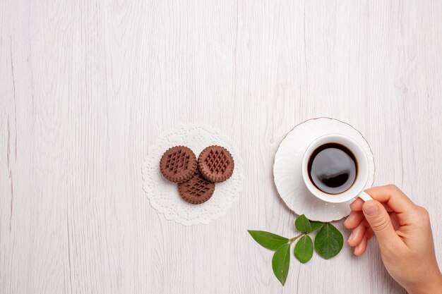 Xícara de chá com biscoitos de chocolate na mesa branca, açúcar, chá, biscoitos, biscoito doce