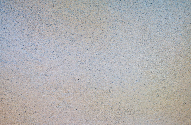 Abstrakte zementwand mit blauem gelbem farbbeschaffenheitshintergrund