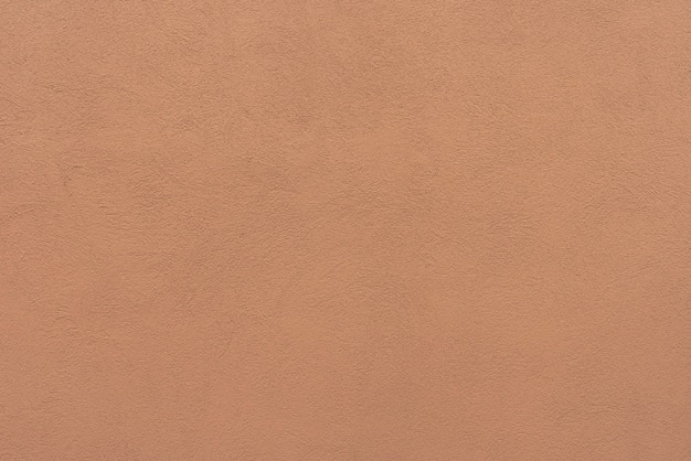 Abstrakter orange Betonmauerhintergrund