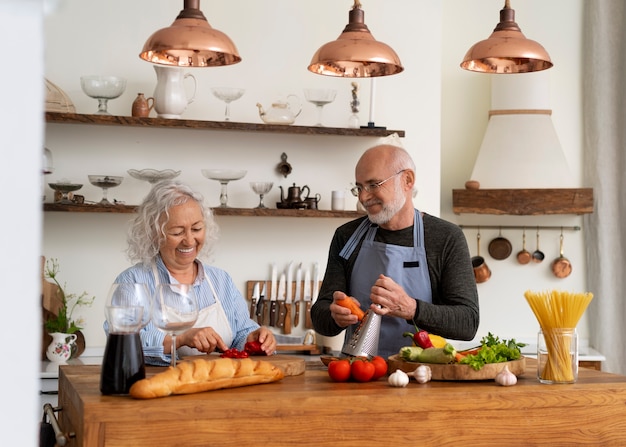 Kostenloses Foto Ältere paare, die zusammen in der küche kochen