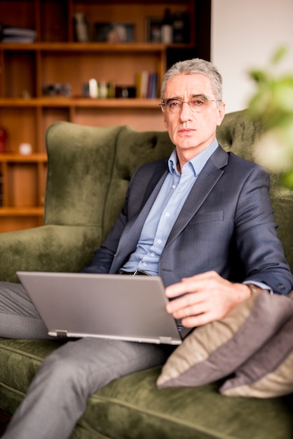 Älterer geschäftsmann mit laptop