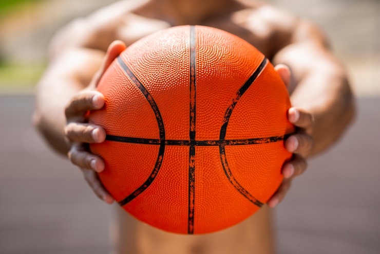 Kostenlose Foto afromann, der einen basketballball hält