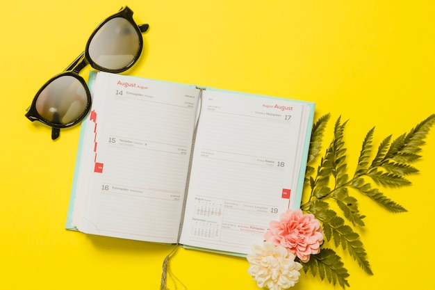 Agenda mit Sonnenbrille und Blumen