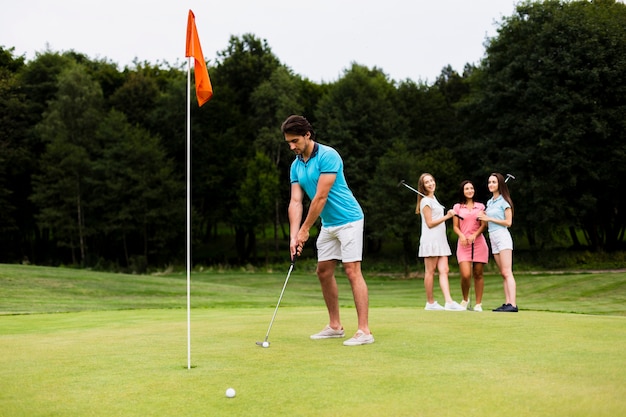 Kostenloses Foto aktiver erwachsener mann, der golf spielt