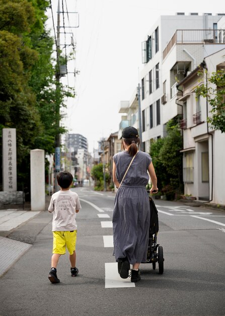 Kostenloses Foto alleinerziehende mutter geht mit ihren kindern spazieren