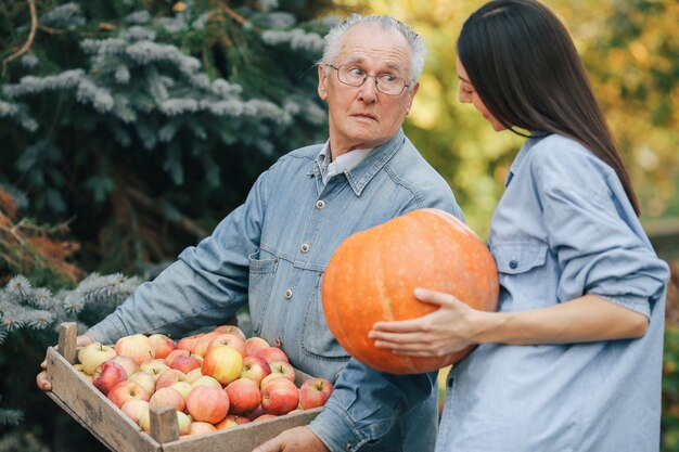 Alter Senior in einem Sommergarten mit Enkelin