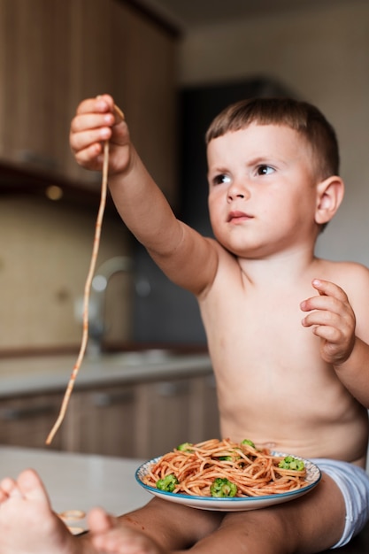 Kostenloses Foto angebotspaghettis des netten jungen