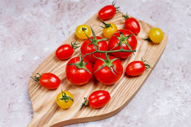 Anordnung für bunte frische sortierte Tomaten auf Betondecke