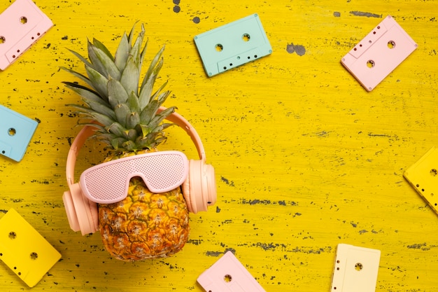 Kostenloses Foto ansicht der ananasfrucht mit cooler sonnenbrille und kopfhörern