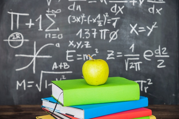 Apple auf Buchstapel nahe Tafel