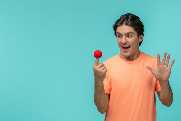 April Fools Day Kerl glücklich mit roter Nase auf der Fingerspitze Clown lustiges glückliches Gesicht Hand Stoppschild