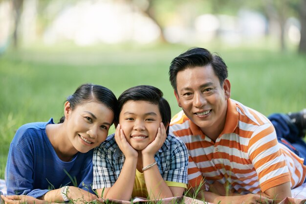 Asiatische Familie am grünen allgemeinen Park