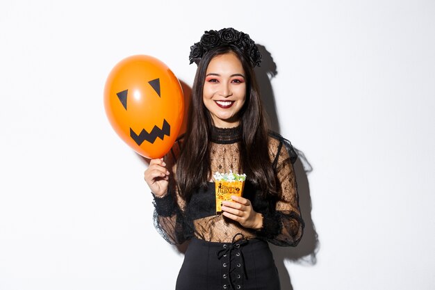 Asiatische Frau im Halloween-Kostüm, das aufwirft