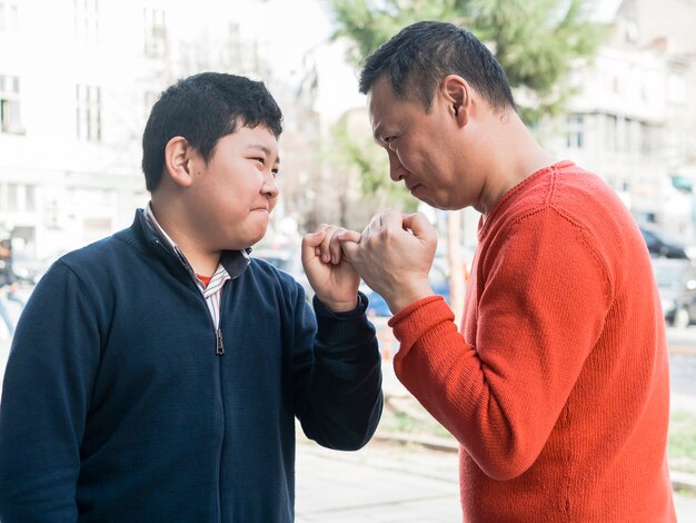 Asiatischer Vater und Sohn machen ein Versprechen