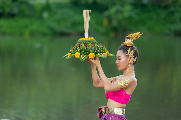 Kostenloses Foto asien frau in thailändischer kleidung traditionell halten kratong. loy krathong festival