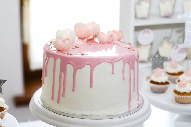 Atemberaubender Geburtstagskuchen bedeckt mit rosa Zuckerglasur und Rosen