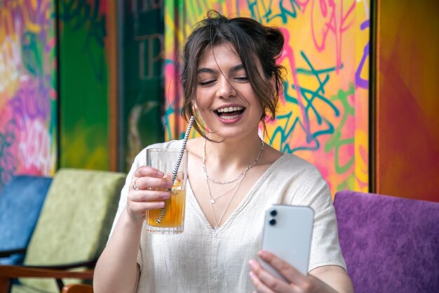 Attraktive junge Frau macht ein Selfie mit einem Glas Limonade