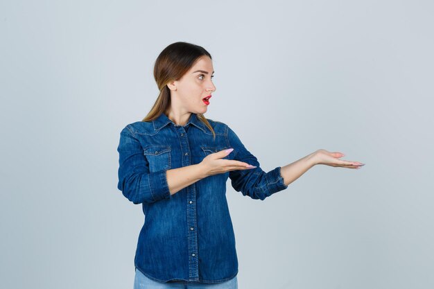 Ausdrucksstarke junge Dame, die im Studio aufwirft