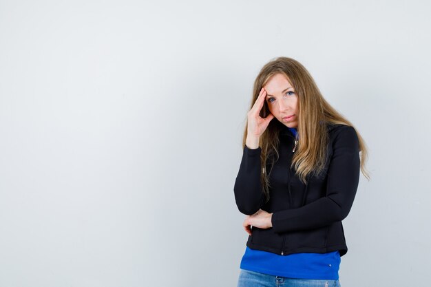 Ausdrucksstarke junge Frau, die im Studio aufwirft