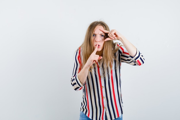 Ausdrucksstarke junge Frau, die im Studio aufwirft