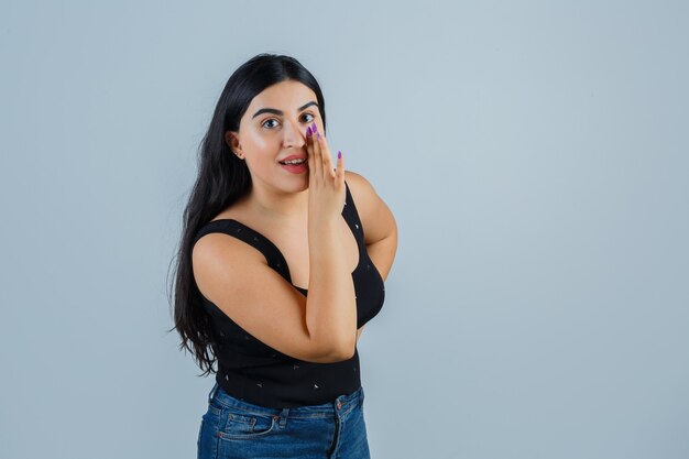 Ausdrucksstarke junge Frau, die im Studio aufwirft