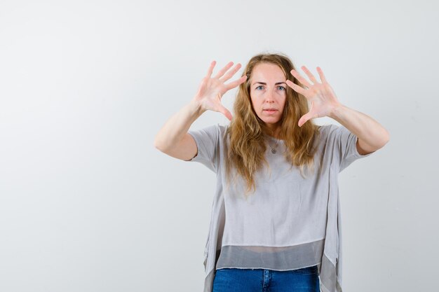 Ausdrucksstarke junge Frau, die im Studio aufwirft