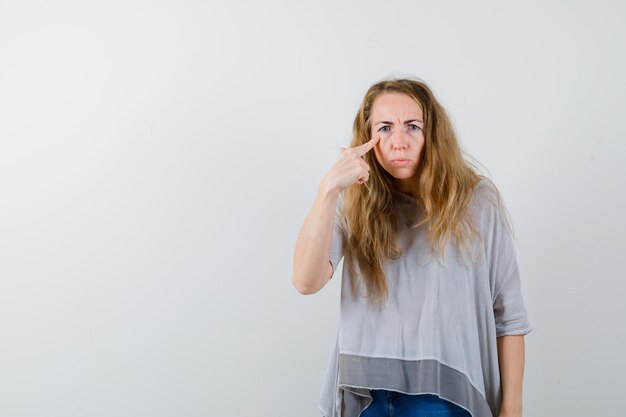 Ausdrucksstarke junge Frau, die im Studio aufwirft