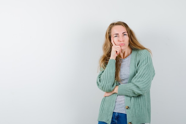 Ausdrucksstarke junge Frau, die im Studio aufwirft