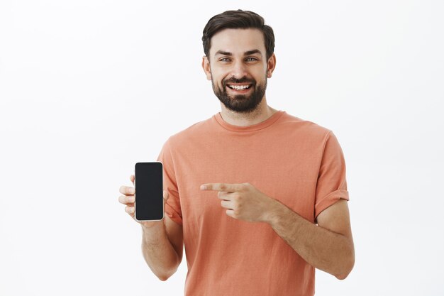 Ausdrucksstarker bärtiger Mann im orangefarbenen T-Shirt