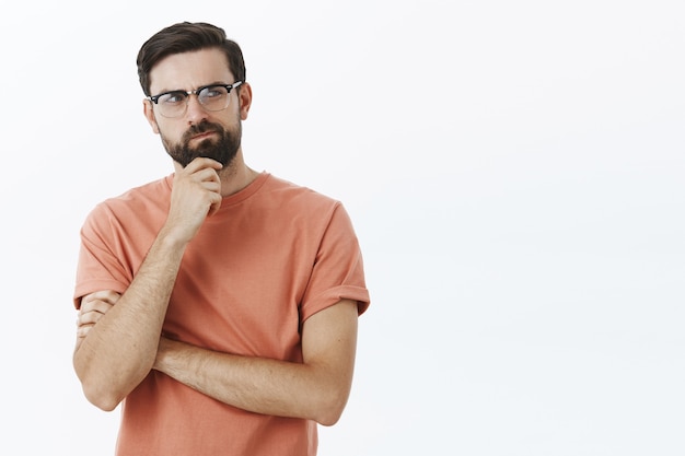 Ausdrucksstarker bärtiger Mann im orangefarbenen T-Shirt