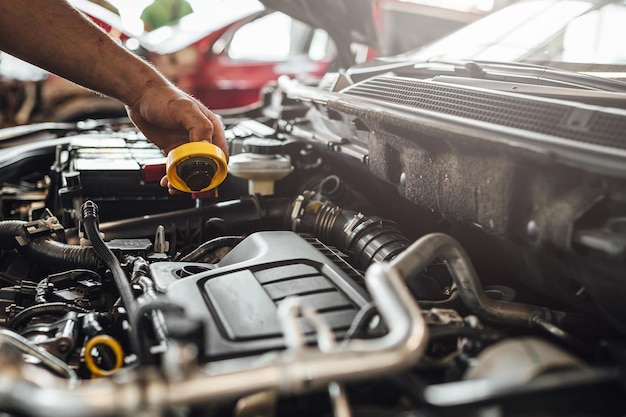 Automechaniker, der an einer technischen Autoinspektion eines Automotors arbeitet