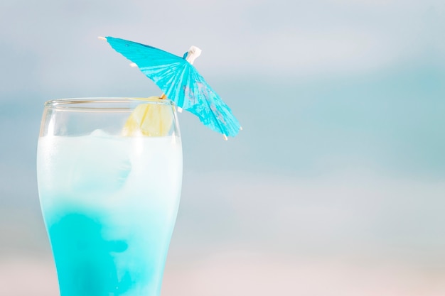 Azurblaues Cocktail mit Regenschirm im Glas