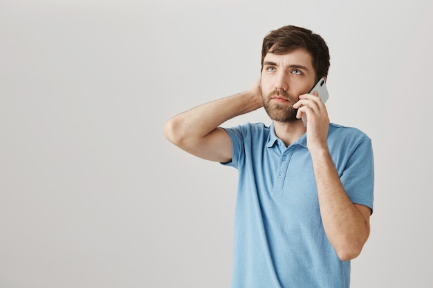 Bärtiges Porträt eines jungen Mannes mit blauem T-Shirt