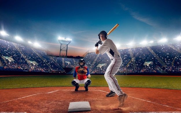 Kostenloses Foto baseballspieler im professionellen baseballstadion am abend während eines spiels