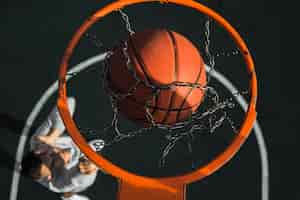 Kostenloses Foto basketball, der oben durch ringabschluß fällt