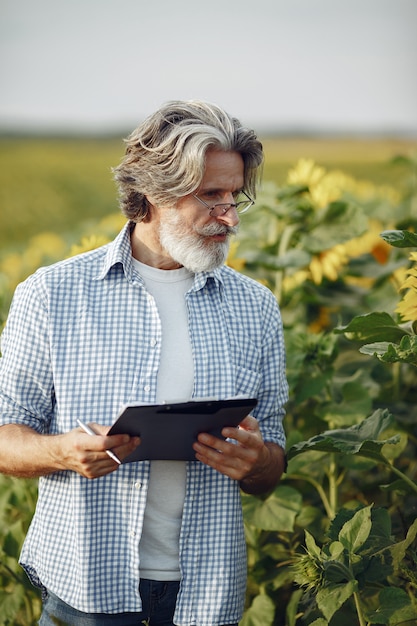 Kostenloses Foto bauer untersucht das feld. agronom oder landwirt untersucht das wachstum von weizen.