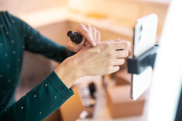 BB Cream. Junge Kosmetikerin demonstriert neue Töne von BB-Creme