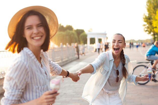 Beste Freunde, die ihre Hände halten und lachen