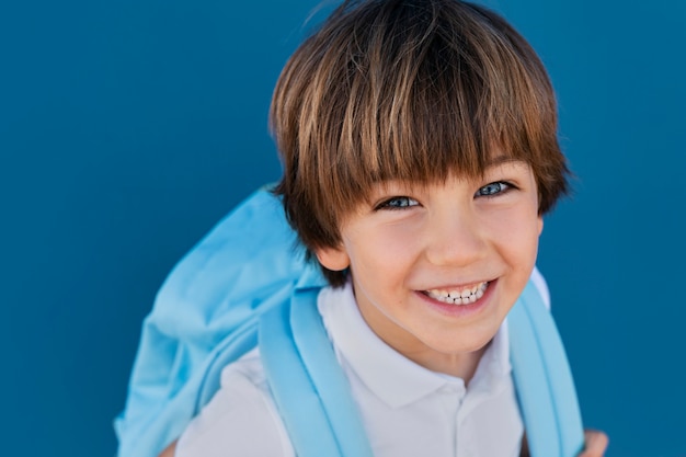 Kostenloses Foto blick auf das smiley-kind, das zurück zur schule geht