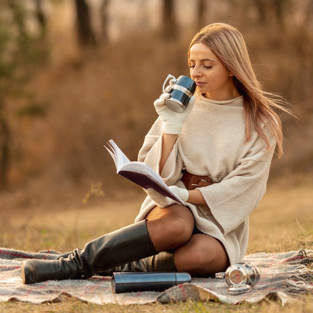 Blonde frau, die ein buch liest