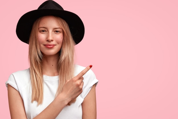 Blonde Frau, die großen Hut und lässiges T-Shirt trägt