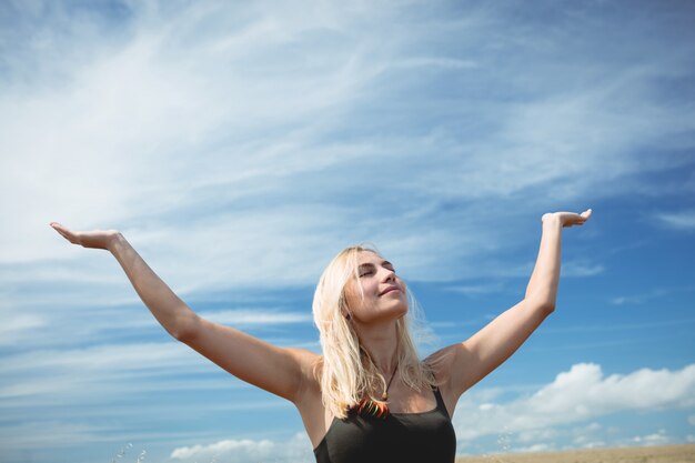 Blonde Frau, die im Feld steht