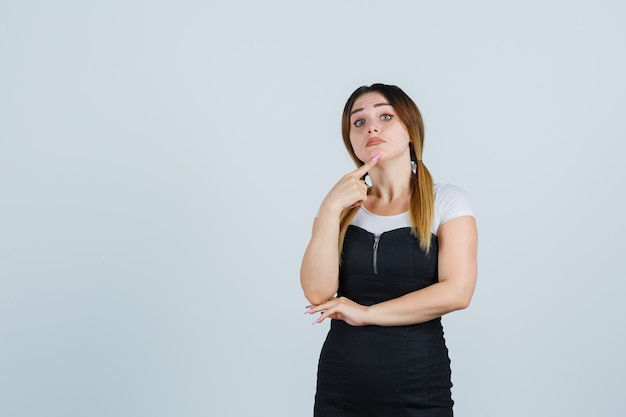 Blonde junge Dame im Kleid gestikuliert isoliert